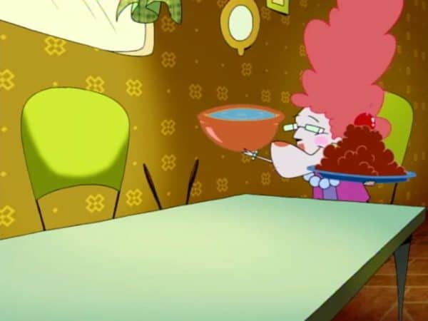 The distance between Eustace and his mother is visually depicted with the empty table between them filling most of the screen.