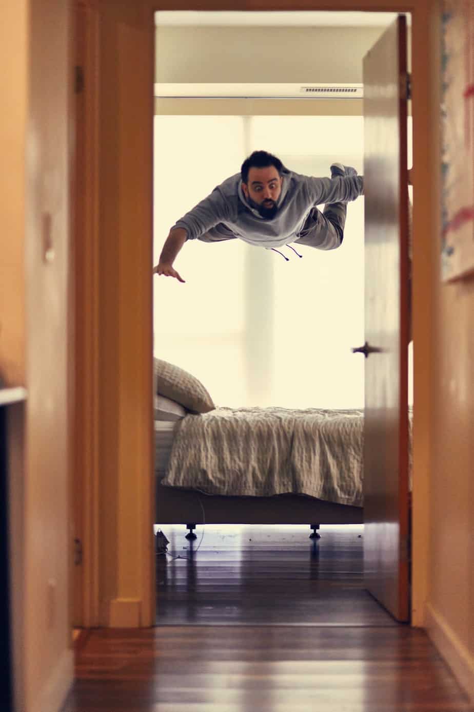 man flies above his bed