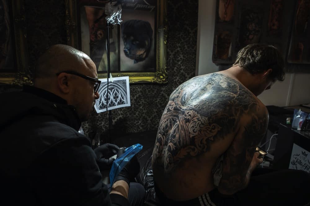 man gets inked in a tattoo parlour