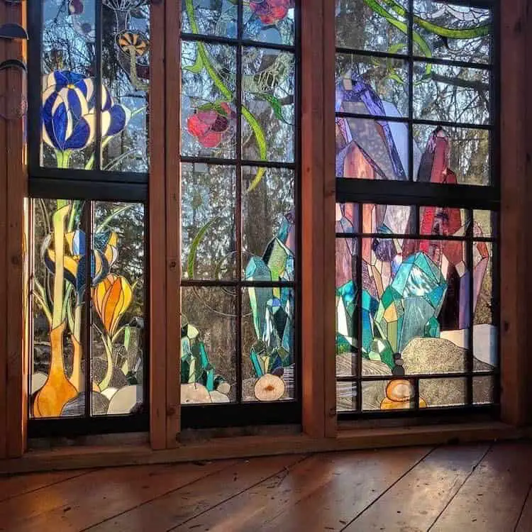 Neile Cooper made a stained glass cabin that she’s decorated with nature inspired imagery.  She uses  it as a sanctuary