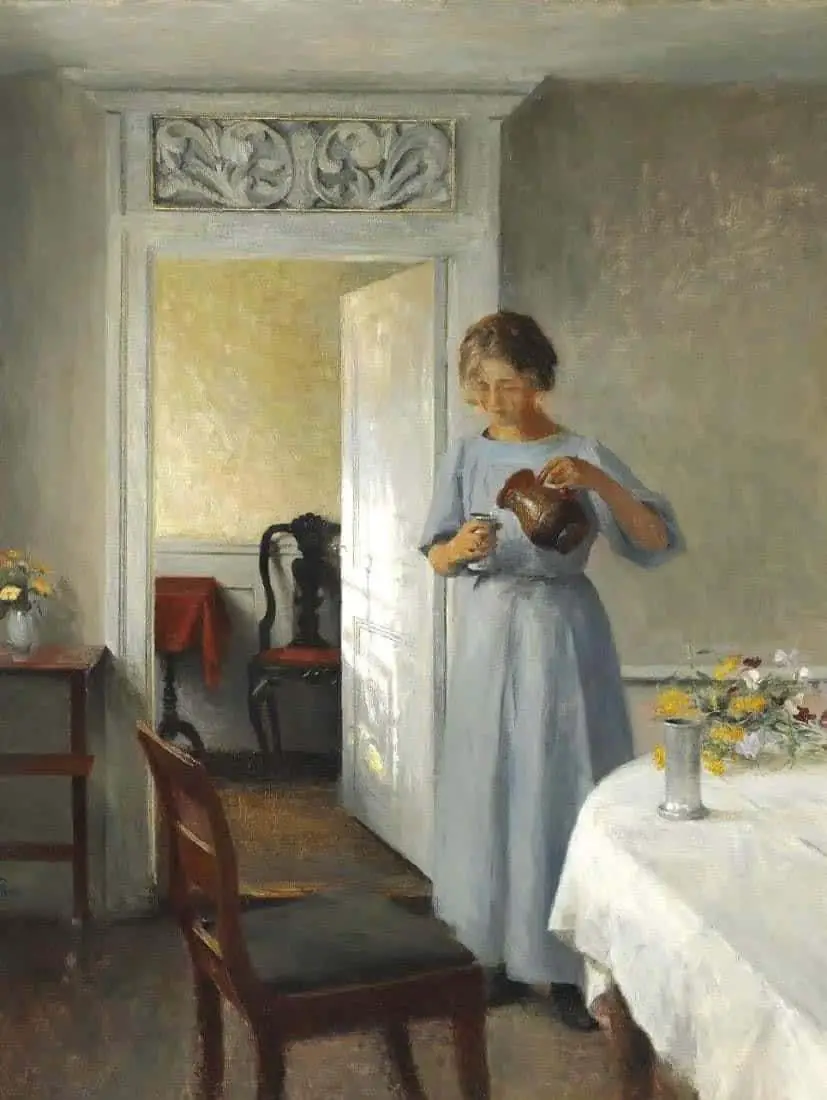 Peter Ilsted (Danish, 1861 - 1933) Young girl in a light blue dress arranges flowers, 1908