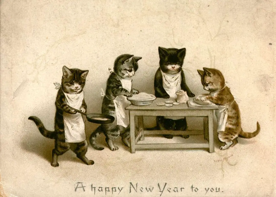 A vintage New Year's postcard by Helena Maguire showing four cats cooking and baking and wishing 'A Happy New Year to you'