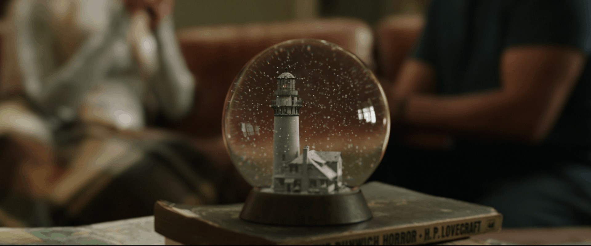 Snow globe close up from the film Aquaman. Notice which books it's sitting on top of.