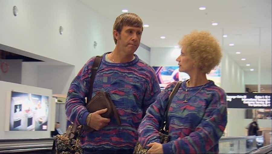 Despite their loud jumpers, Kath and Kel are structurally invisible during their tourist experience at the airport.