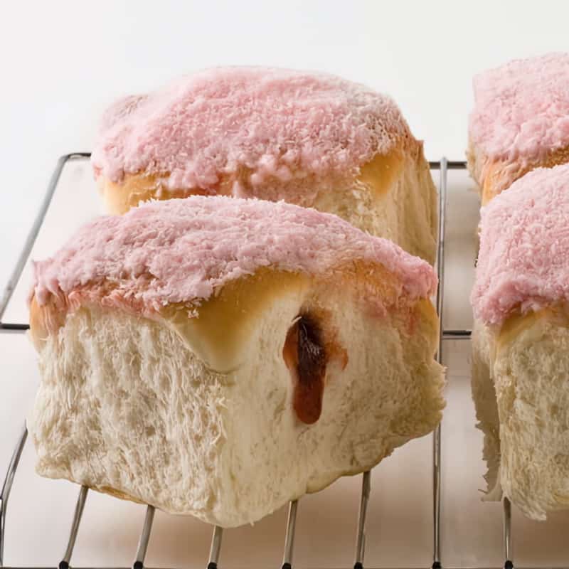 raspberry buns with jam seeping out of the bread