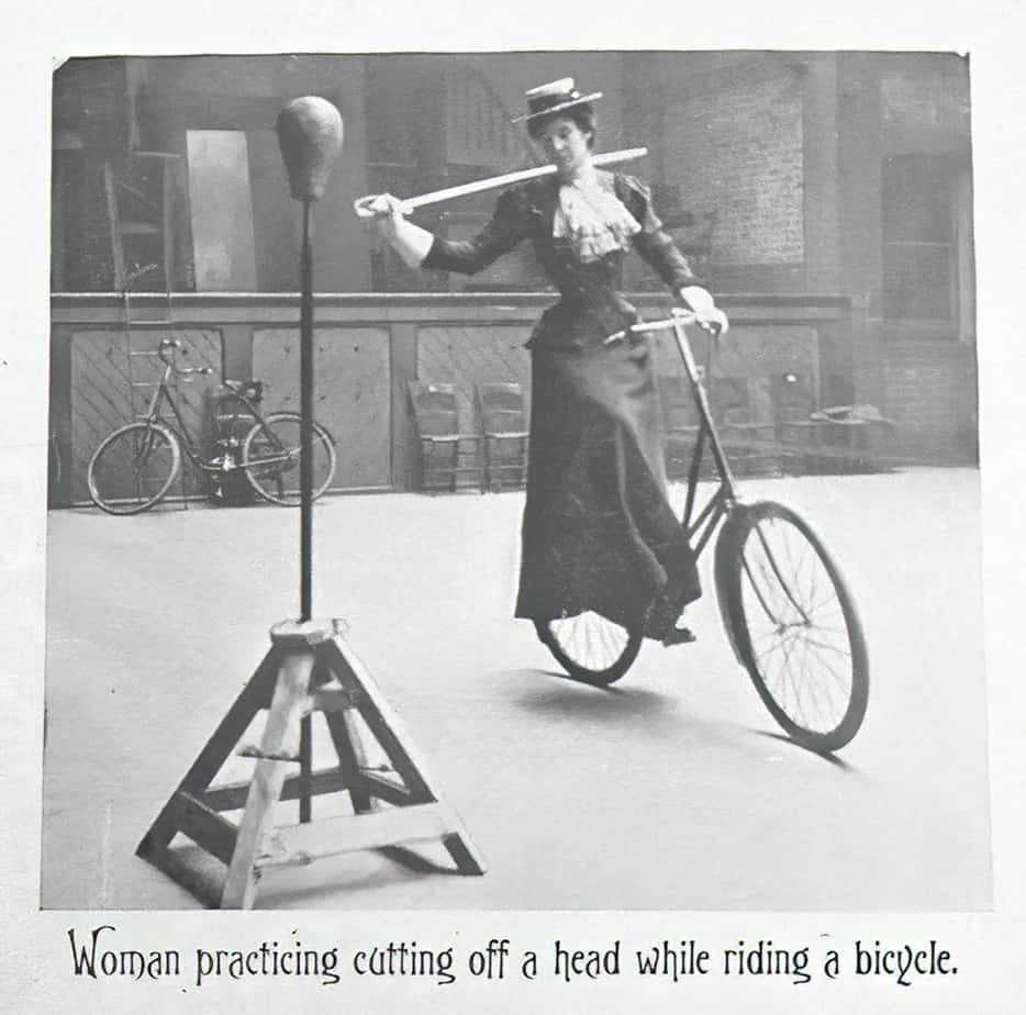 Woman practising cutting off a head while riding a bicycle